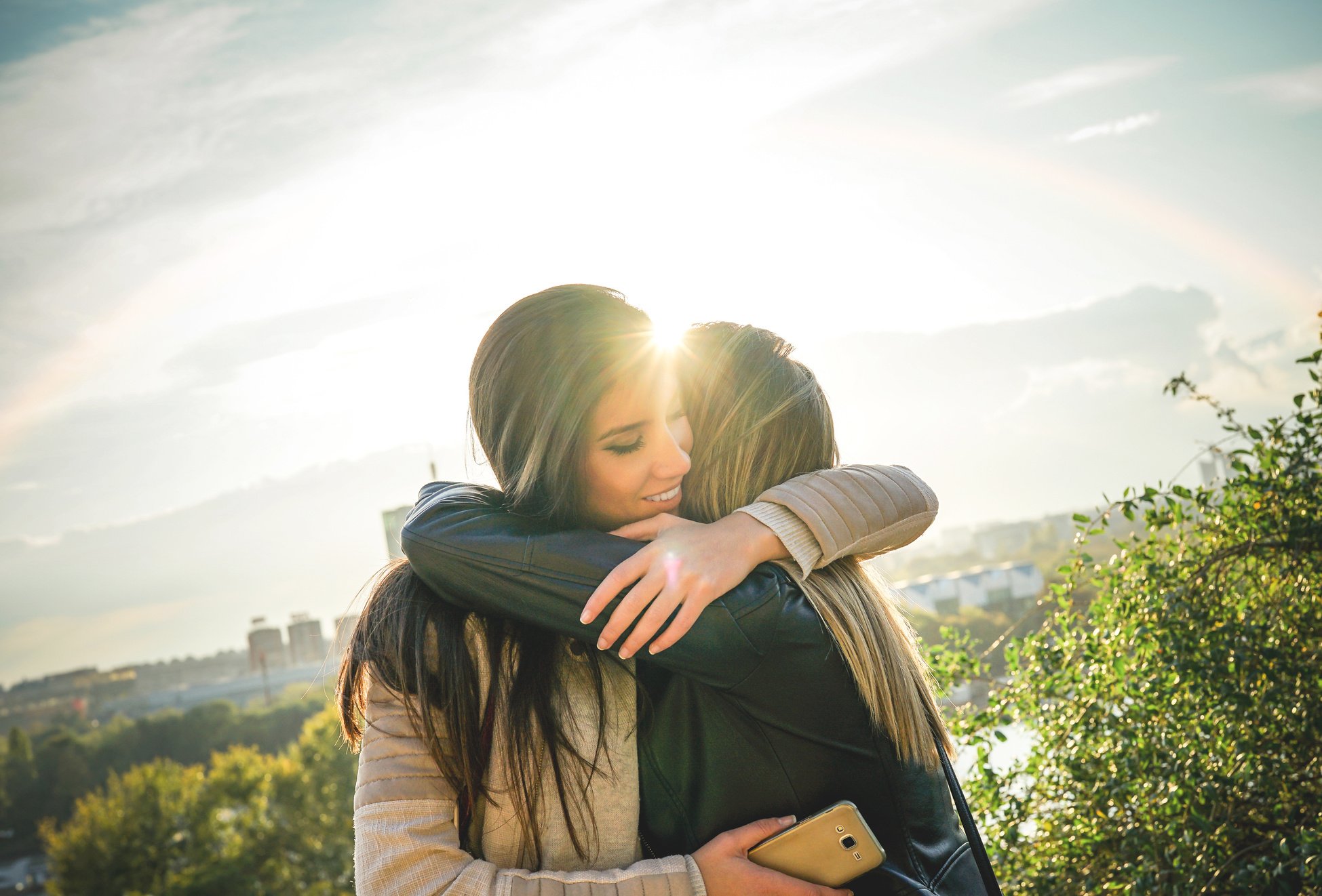 Friends Hugging During Sunset Outdoor